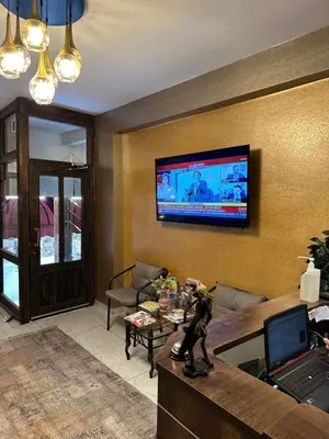 a living room with a television on a wall at Galapera Hotel in Istanbul