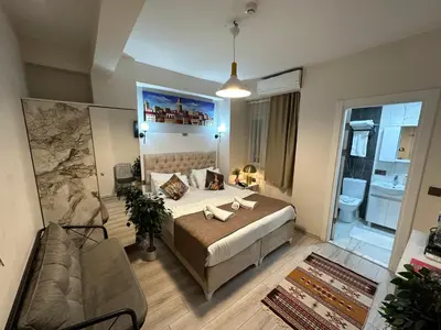 a bedroom with a bed and a couch in a room at Galapera Hotel in Istanbul