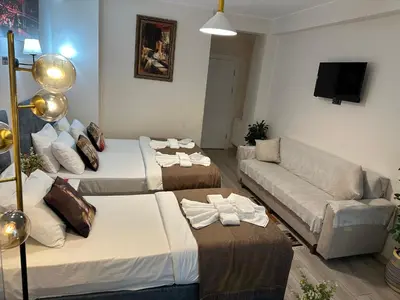 a living room with two beds and a couch at Galapera Hotel in Istanbul