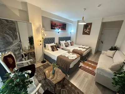 a hotel room with two beds and a couch at Galapera Hotel in Istanbul