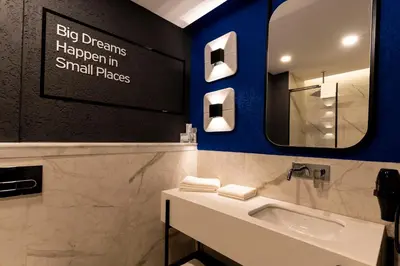 a bathroom with a sink and a mirror at Hotel Bonvie in Sakarya