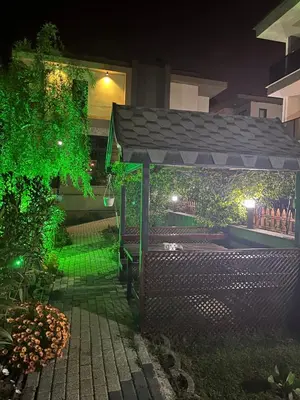 a gazebo in a yard at night at Golden Hour Apartment بورصة شقة مريحة Bursa Nilufer مَنْظَرٌ جَمِيلٌ in Nilüfer