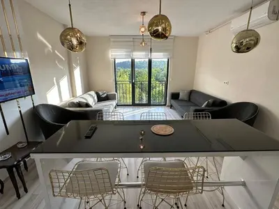 a living room with a ping pong table and chairs at Golden Hour Apartment بورصة شقة مريحة Bursa Nilufer مَنْظَرٌ جَمِيلٌ in Nilüfer