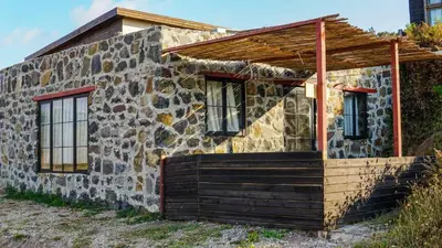 an old stone house with a porch and windows at Sahil Kamp İstanbul Hotel in Sile