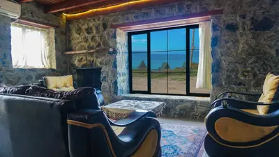 a living room with two chairs and a large window at Sahil Kamp İstanbul Hotel in Sile