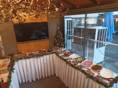 a table with food and a christmas tree in a room at Arach Hotel Harbiye in Istanbul