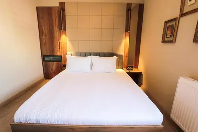 a bedroom with a white bed with two pillows at Arach Hotel Harbiye in Istanbul