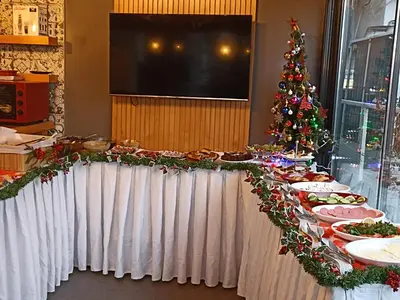 a table with christmas food and a christmas tree at Arach Hotel Harbiye in Istanbul