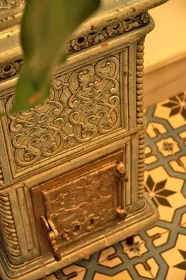 a close up of a wooden table with a plant at Tilas - Rooms in 19th Century Wooden Townhouse,Kadikoy in Istanbul