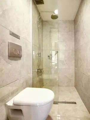 a bathroom with a toilet and a glass shower at Duo Galata Hotel in Istanbul