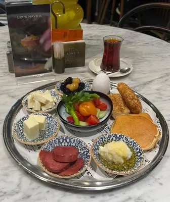 a tray of different types of food on a table at Duo Galata Hotel in Istanbul