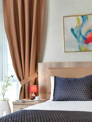 a bedroom with a bed and a curtain at Jaff Hotels & Spa Nisantasi in Istanbul