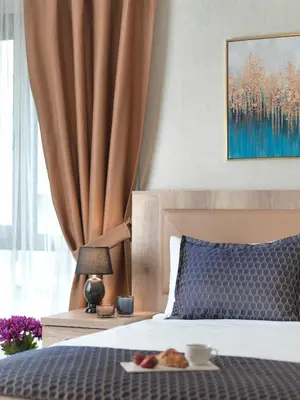 a bedroom with a bed with a plate of food on it at Jaff Hotels & Spa Nisantasi in Istanbul