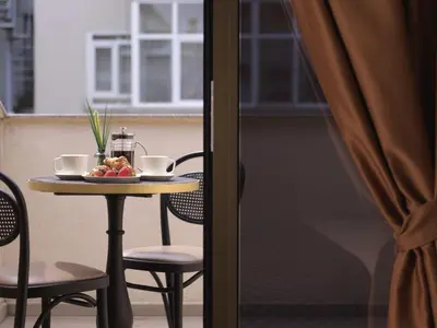 a table with a bowl of fruit and two cups at Jaff Hotels & Spa Nisantasi in Istanbul