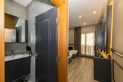 a bathroom with a sink and a toilet at Confores Hotel in Istanbul