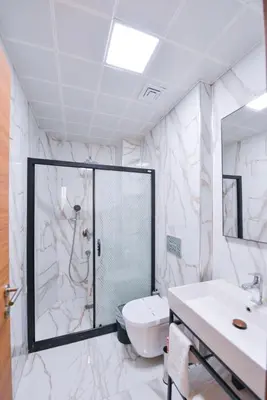 a bathroom with a shower and a toilet and a sink at İstport Hotels in Arnavutköy