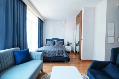 a bedroom with a bed and a couch at SABİHA GOKCEN İSTANBUL HOUSES Airport in Istanbul