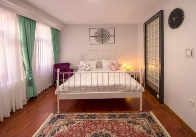 a bedroom with a white bed and a rug at Duru Istanbul Apart in Istanbul