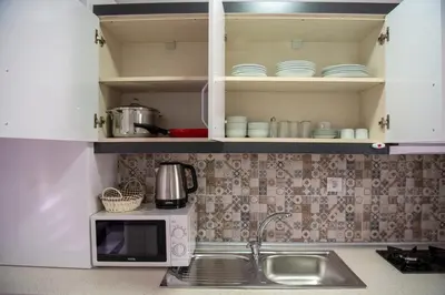 a kitchen with a sink and a microwave at Duru Istanbul Apart in Istanbul
