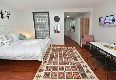 a bedroom with a bed and a table and a desk at Duru Istanbul Apart in Istanbul