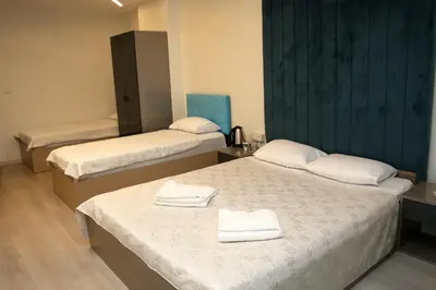 two beds in a room with white towels on them at Blueway Hotel Istanbul Bakırköy City Center in Istanbul