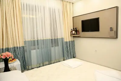 a hotel room with a tv and a window at Blueway Hotel Istanbul Bakırköy City Center in Istanbul