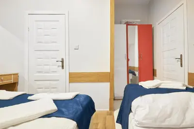 a bedroom with two beds and a mirror at Central Suites Taksim in Istanbul