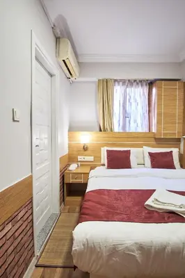 a hotel room with two beds and a window at Central Suites Taksim in Istanbul