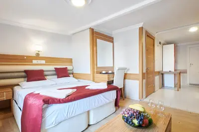 a bedroom with a bed and a bowl of fruit on a table at Central Suites Taksim in Istanbul