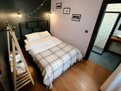 a bedroom with a bed with a plaid blanket at Le Banc in Istanbul