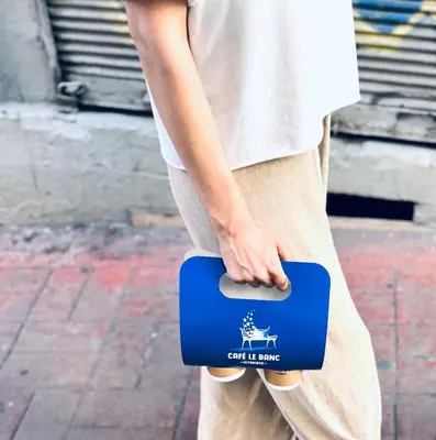 a person holding a blue and white briefcase at Le Banc in Istanbul