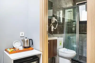 a bathroom with a toilet and a walk in shower at Gloria Suites Old City in Istanbul