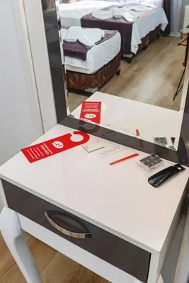 a mirror sitting on top of a white counter with a table at Gloria Suites Old City in Istanbul