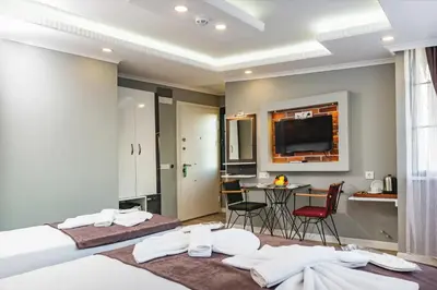 a hotel room with a bed and a table with chairs at Gloria Suites Old City in Istanbul