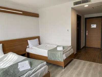 a hotel room with two beds and a hallway at BUSINESS EXPRESS HOTEL in Tekirdag