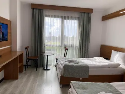 a hotel room with two beds and a window at BUSINESS EXPRESS HOTEL in Tekirdag