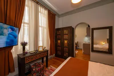 a living room with a bed and a mirror at O'Pera Okanlı Suites in Istanbul