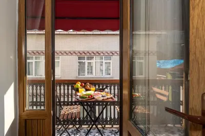 a glass window with a tray of food on a balcony at O'Pera Okanlı Suites in Istanbul