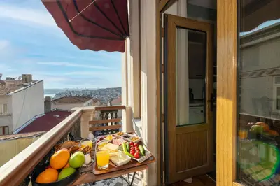 a tray of fruit on a table on a balcony at O'Pera Okanlı Suites in Istanbul