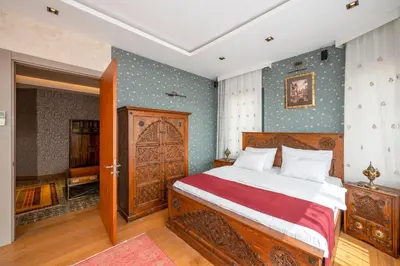 a bedroom with a bed and a wooden door at O'Pera Okanlı Suites in Istanbul