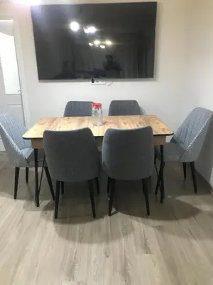 a wooden table with four chairs around it at Hakan’s apartment in Istanbul