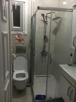 a small bathroom with a shower and a toilet at Hakan’s apartment in Istanbul