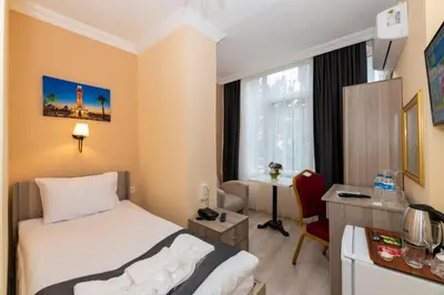 a hotel room with a bed and a desk at Avrupa Palace Hotel in Avcılar