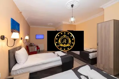 a hotel room with two beds and a poster on the wall at Avrupa Palace Hotel in Avcılar