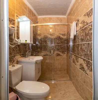 a bathroom with a toilet and a sink and a shower at Avrupa Palace Hotel in Avcılar