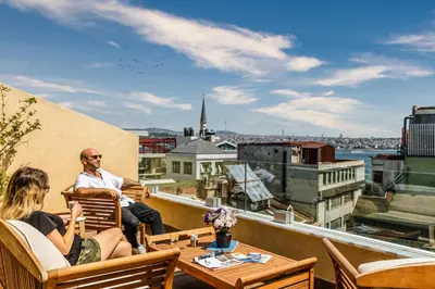 a group of people sitting on the roof of a building at Union Hotel Port in Istanbul