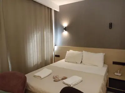 a hotel room with a bed with towels on it at Doğan Palas Suites in Istanbul