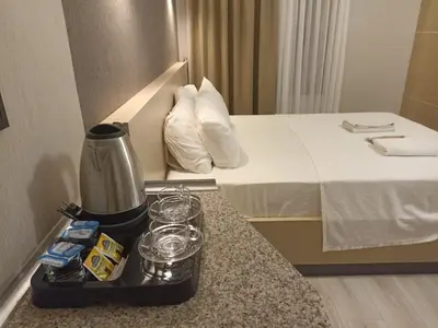 a hotel room with a coffee maker and glasses on a counter at Doğan Palas Suites in Istanbul