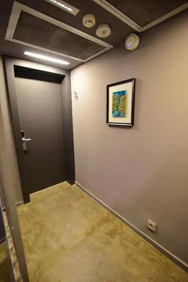 a hallway with a door and a picture on a wall at The Row Taksim Hotel in Istanbul