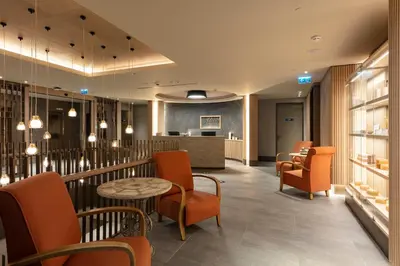 a waiting room with orange chairs and a table at NG Enjoy in Sapanca